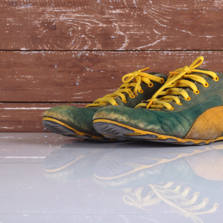 Clothes shoes and accessories - Closeup old pair green and yellow sneakers wooden background with...