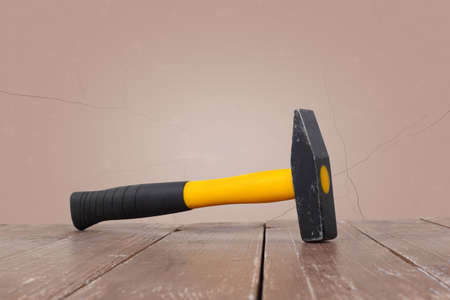 Tools Building and repair - Big hammer on a wooden and brown wall background.の写真素材