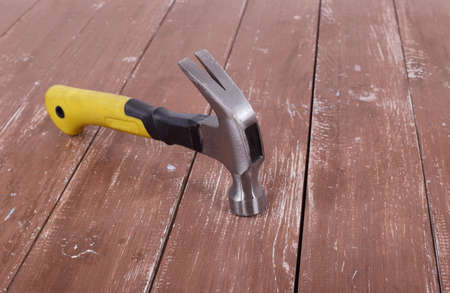 Tools Building and repair - Claw hammer on a wooden background.