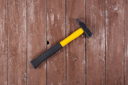 Tools Building and repair - Top view big hammer on a wooden background.の写真素材