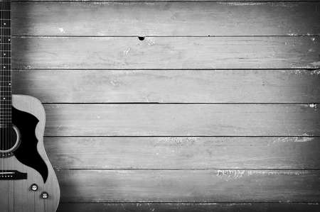 Musical instrument - Classic acoustic guitar on a wooden background monochromeの写真素材