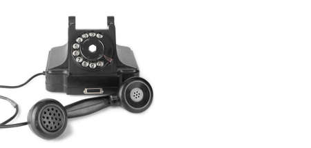 Vintage Phones - Black retro phone is picked up on a white background.