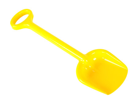 Tools Building and repair - Children Yellow toy shovel with a handle on a white background. It is isolated, the worker of paths is present.の写真素材