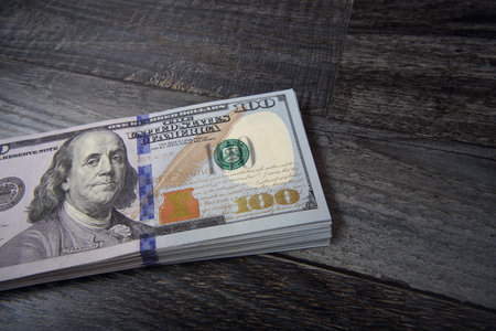 Fragment stack of US dollars on black boards backgroundの写真素材