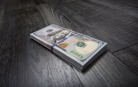 World money - Side view small stack of US dollars on black boards backgroundの写真素材