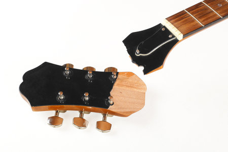 Guitar repair and service - Broken Headstock acoustic guitar isolated white background