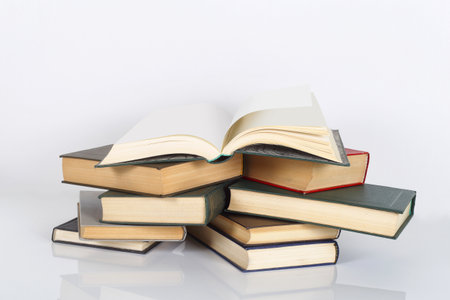 Science and education - Open book on a stack of books white background. With reflection