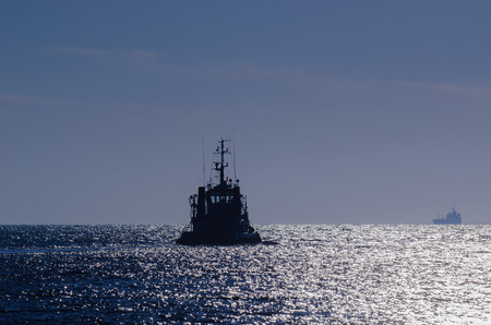 TUGBOAT ON THE SEA. Tug on the calm sea in the sunshineの写真素材