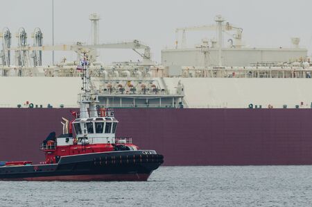 LNG TANKER AND FIREBOAT- Gas Carrier safety secured by fireboat at the gas terminal in the port of...