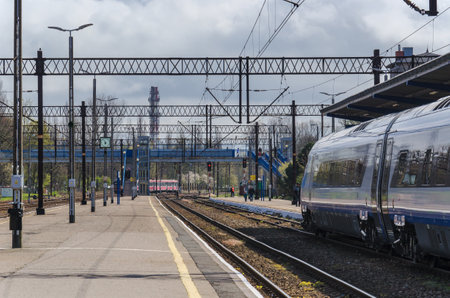 KOLOBRZEG, West Pomeranian / POLAND - APRIL, 2016: Express train waiting for passengers at the platform at the train stationのeditorial素材