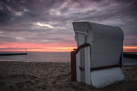 SUNSET BY SEA COAST - Beach basket on the sea beachの写真素材