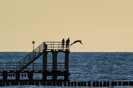 BEACH HOLIDAY - Small coastal pier at sunsetの写真素材