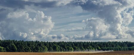 LATE SUMMER LANDSCAPE - September sky overcast over fields and forestsの写真素材