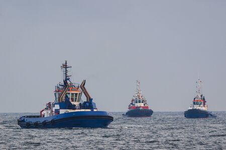 TUGS - Two tugs and fireboat at seaの写真素材