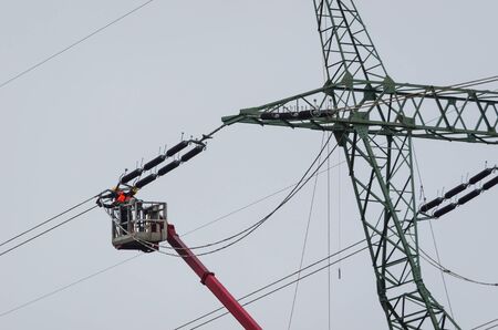 POWER ENGINEERS - High-voltage line fastened on a great tower truss