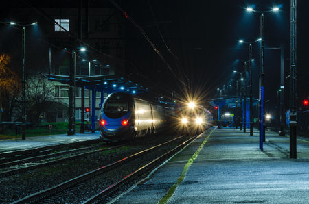 KOLOBRZEG, WEST POMERANIAN / POLAND - Two express trains waiting for passengers at the train stationのeditorial素材