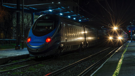 KOLOBRZEG, WEST POMERANIAN / POLAND - Two express trains waiting for passengers at the train stationのeditorial素材