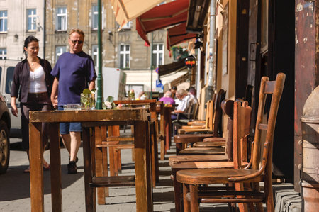 KRAKOW, KAZIMIERZ / POLAND: Cafe chairs and tables in the morning on the old historic streetsのeditorial素材