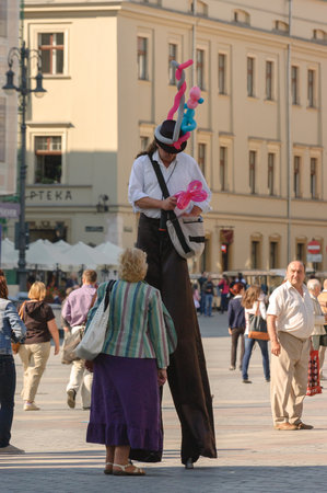 KRAKOW / POLAND: Main square and man on Stilts - Holiday tourist in old townのeditorial素材