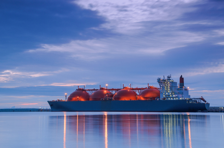 LNG TANKER AT THE GAS TERMINAL - Sunrise over the ship and portの写真素材
