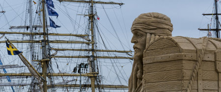 SZCZECIN, WEST POMERANIAN / POLAND - 2017: Tall Ships Races - Pirate's sculpture from the sand and his treasure chest in the marinaのeditorial素材