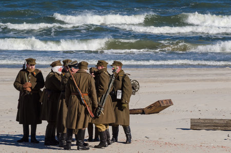 KOLOBRZEG, WEST POMERANIAN / POLAND - 2018: Reconstruction of battle for Ko?obrzeg - Reconstruction group of 1nd Polish Army on sea beach at briefing before the battleのeditorial素材