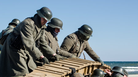 KOLOBRZEG, WEST POMERANIAN / POLAND - 2018: Reconstruction of battle for Ko?obrzeg - Reconstruction group in uniforms of Wehrmacht on a German armored personnel from the eraのeditorial素材