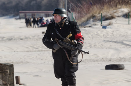 KOLOBRZEG, WEST POMERANIAN / POLAND - 2018: Reconstruction of battle for Kolobrzeg - Nazi on the sea beachのeditorial素材