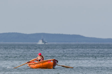 MIEDZYZDROJE, WEST POMERANIAN / POLAND - 2017: A lifeguard in a lifeboat patrols the sea coast