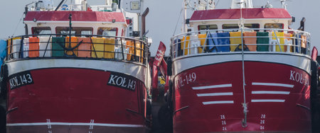 KOLOBRZEG, WEST POMERANIAN / POLAND - 2018: Fishing boats moored at the port quayのeditorial素材