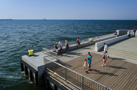 KOLOBRZEG, WEST POMERANIAN / POLAND - 2018: Summer - Holidaymakers are walking on the pierのeditorial素材