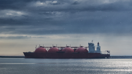 LNG TANKER - Rain and stormy dramatic clouds over a gas terminal in Swinoujscieの写真素材