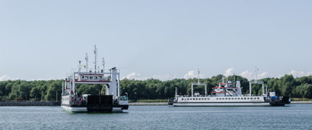 SWINOUJSCIE, WEST POMERANIAN / POLAND - 2018: Cars and people on a ferry crossing the river