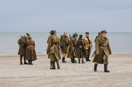 KOLOBRZEG, WEST POMERANIAN / POLAND - 2019: Reconstruction of battle for Kolobrzeg - Soldiers of the Polish Army on the sea beach await the battleのeditorial素材