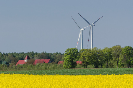 WIND FARM - Traditional rural landscape in spring and modern ecological technologyの写真素材
