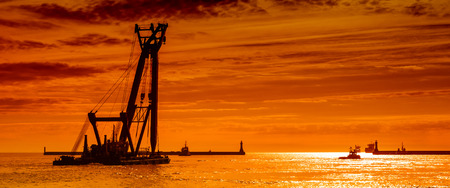 SEA CRANE - A large floating machine is being manned in a port