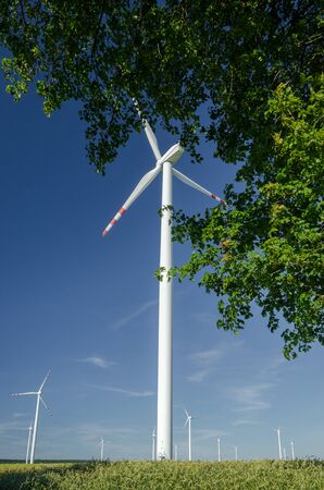 WIND FARM - Renewable energy sources against a blue sky