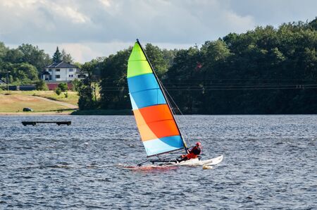 REGATTA IN SUNNY RAYS - Sailboat on the waves of the lakeの写真素材