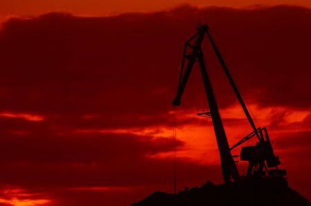 PORT CRANE - Fiery morning over the transhipment terminal in the seaportの写真素材