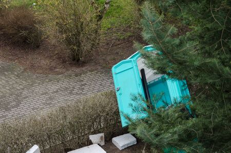 AN OVERTURNED PORTABLE TOILET - Garbage in the city landscapeの写真素材