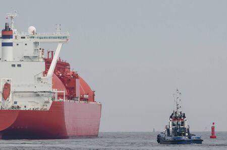LNG TANKER - The beautiful red ship flows to the gas terminal unloading quayの写真素材
