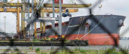 SWINOUJSCIE, WEST POMERANIAN / POLAND - 2020: Merchant vessel at the transhipment terminal in a seaportのeditorial素材