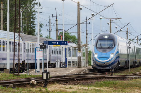 USTRONIE MORSKIE, WEST POMERANIAN / POLAND - 2020: The express train goes through a small station on the railway routeのeditorial素材