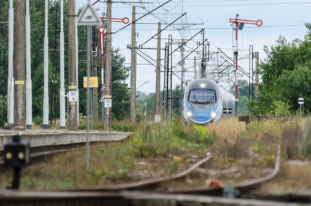 USTRONIE MORSKIE, WEST POMERANIAN / POLAND - 2020: The express train goes through a small station on the railway routeのeditorial素材