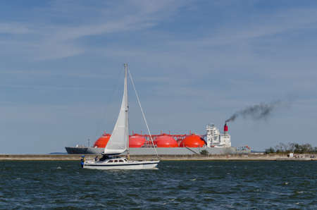 SAILBOAT AND LNG TANKER - Landscape of the sea coastの写真素材