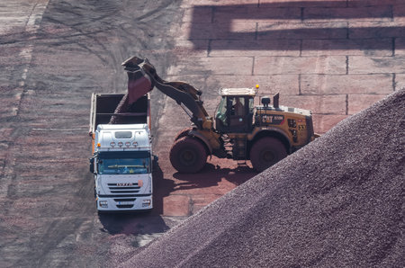 SWINOUJSCIE, WEST POMERANIAN / POLAND - 2020: Truck and wheel loading in the mineral material storage yardのeditorial素材