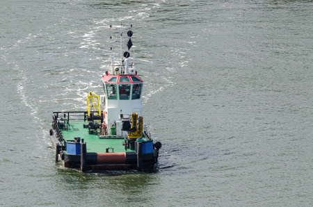 TUGBOAT - A small auxiliary ship is maneuvering at seaの写真素材