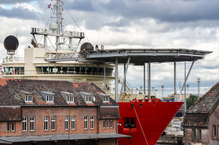 SHIP IN SEAPORT - Specialized watercraft moored at the wharf against the background of old...