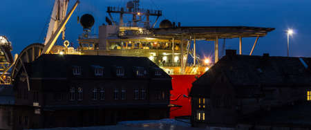 SHIP IN SEAPORT - Specialized watercraft moored at the wharf against the background of old...