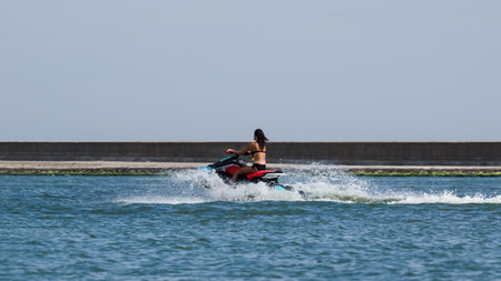 SWINOUJSCIE, WEST POMERANIAN - POLAND - 2020: The woman is swimming on the jet ski